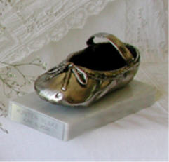 Pewter finished shoe on white marble paperweight